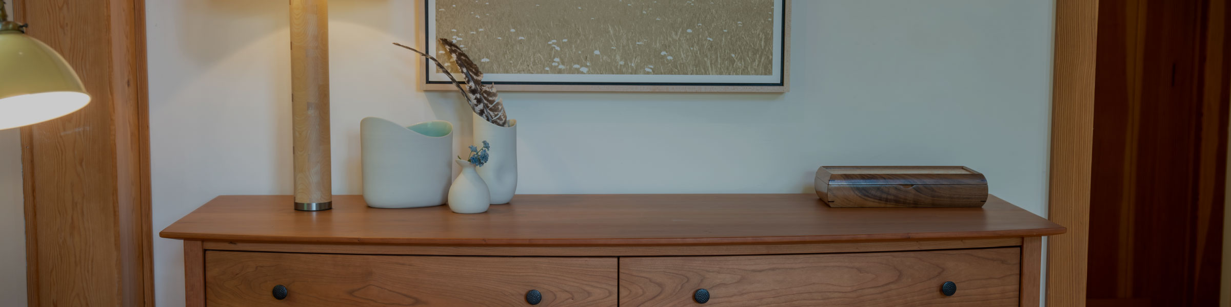 close up of dresser top with lamp, pottery and jewelry box