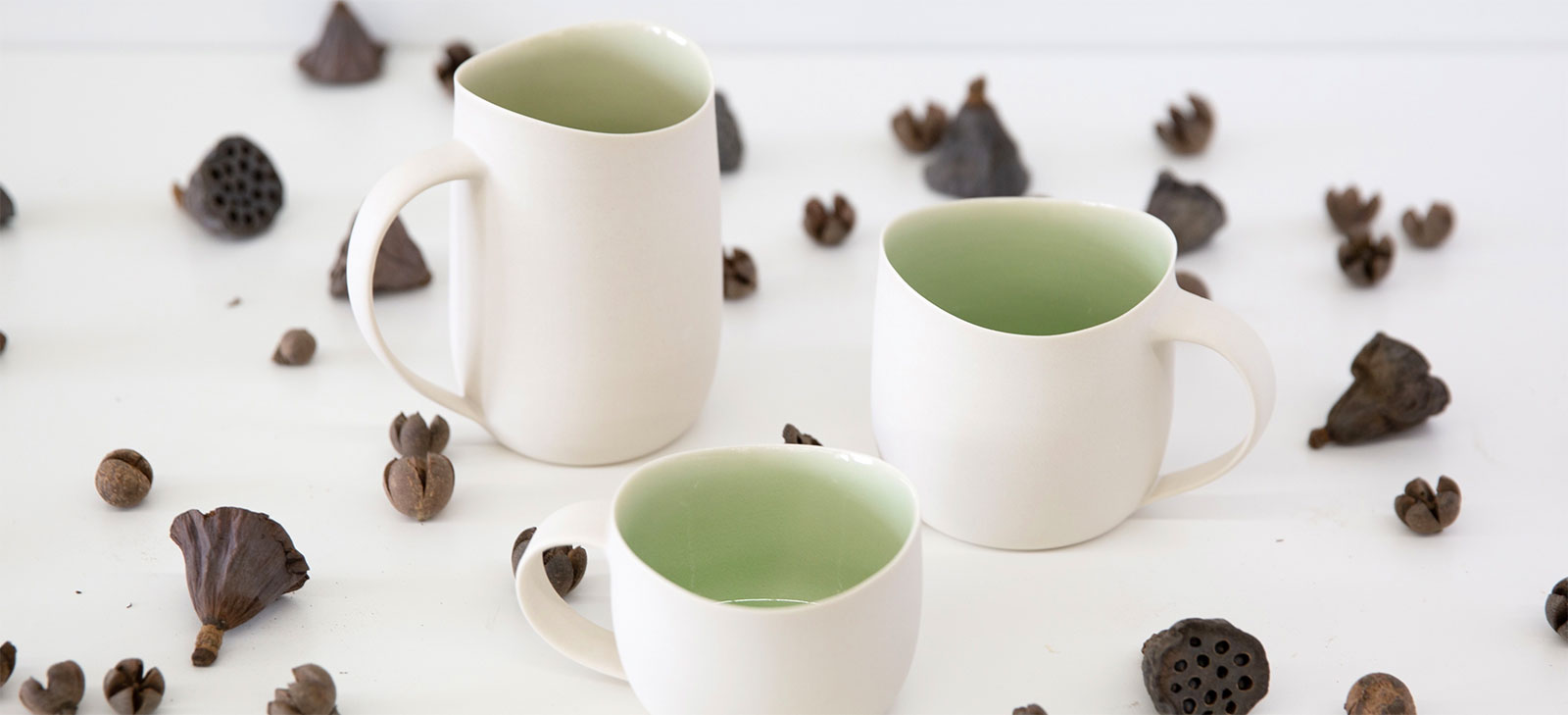 white and light green coffee  mugs