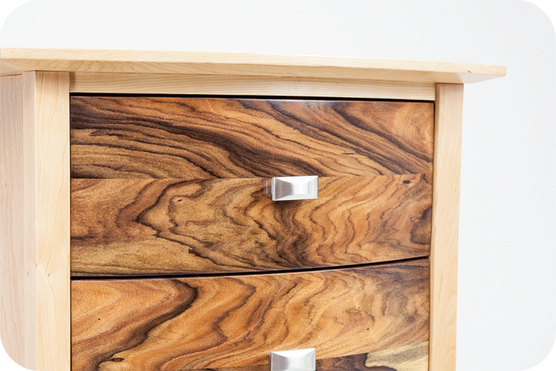 close up of front of dresser with mixed wood