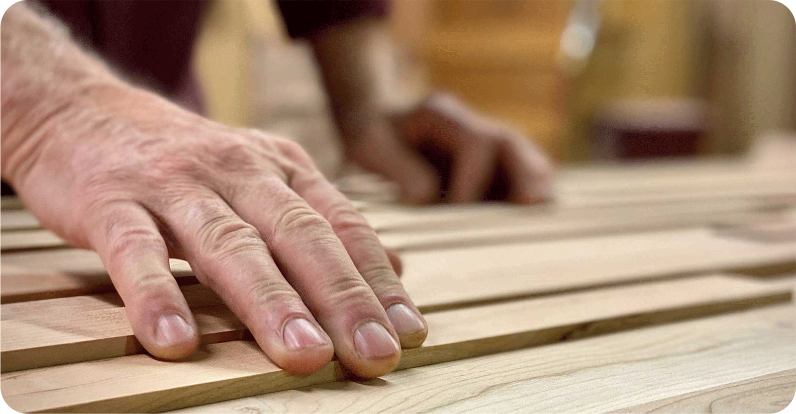 a man's hands building furniture