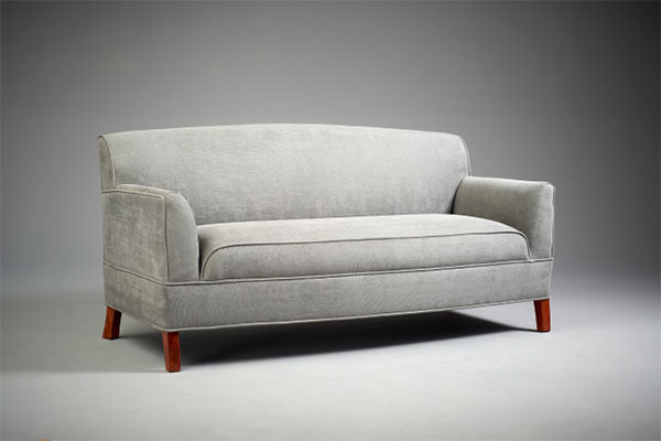 grey velvet couch with cherry wood legs