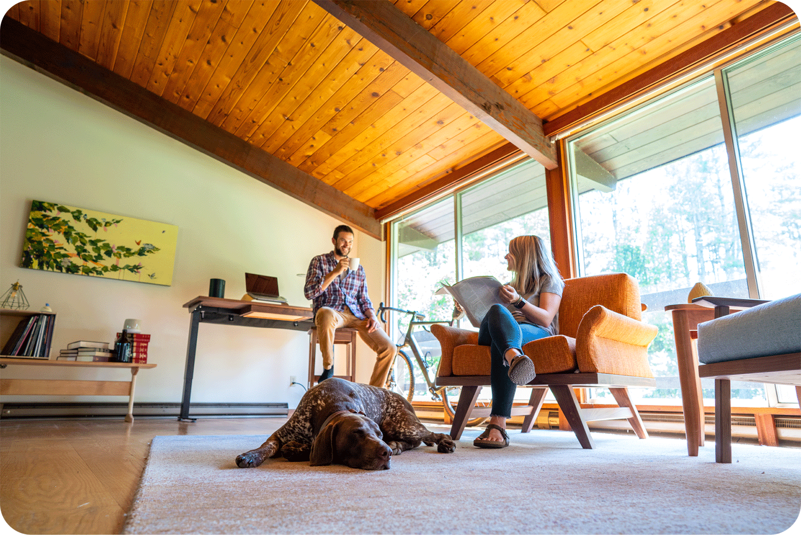 young couple and dog hanging out in modern house living room